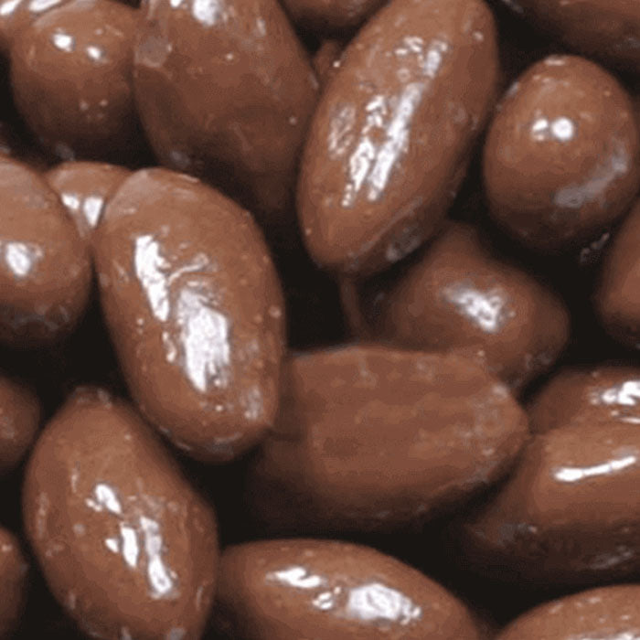 Close-up of chocolate-covered almonds with a glossy finish.