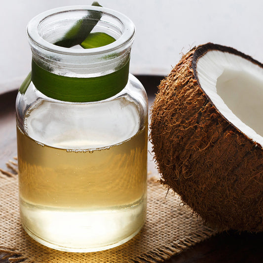 Pure Coconut Oil in glass jar and Half Coconut