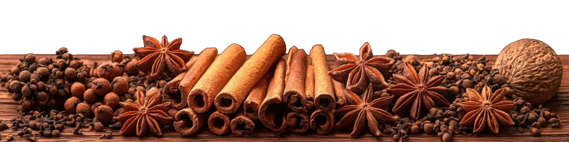 Spices including cinnamon sticks, star anise, and a walnut  